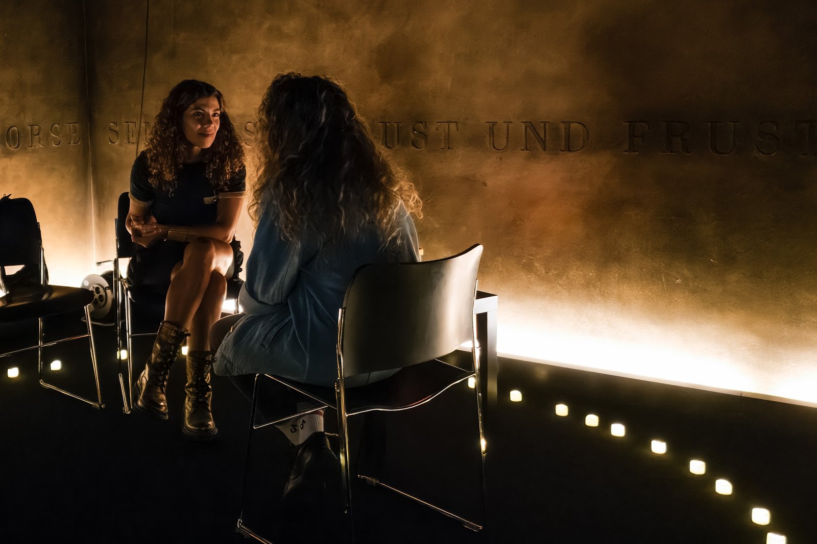 A reading in progress in the candle-lit exhibition room